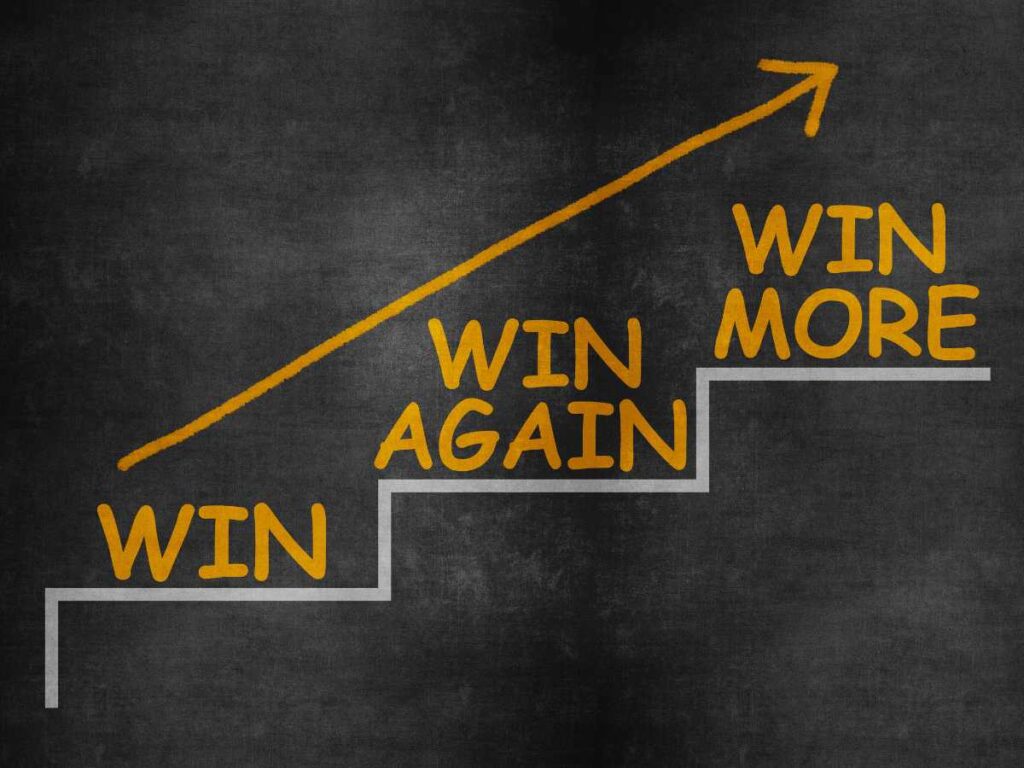 Redefining success: image of stairs that says win, win again, and win more