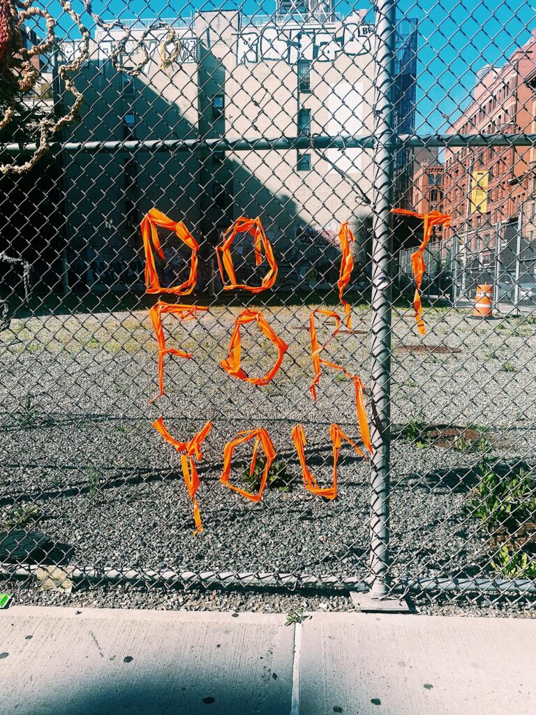words on a metal gate that say "do it for you". This is for a blog post on negative thoughts and negative self talk